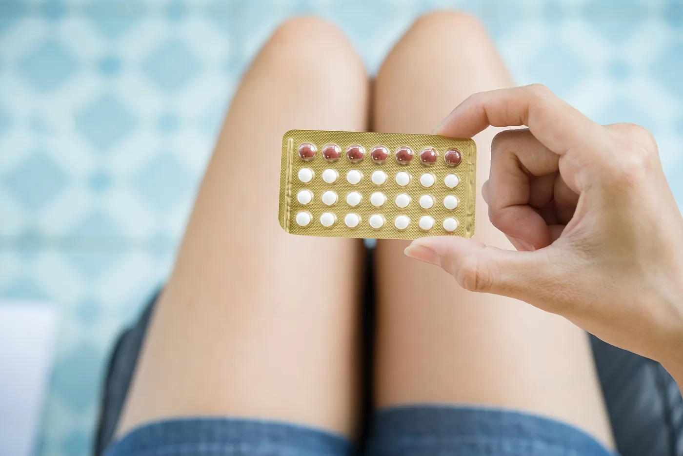 Woman holding contraception pill